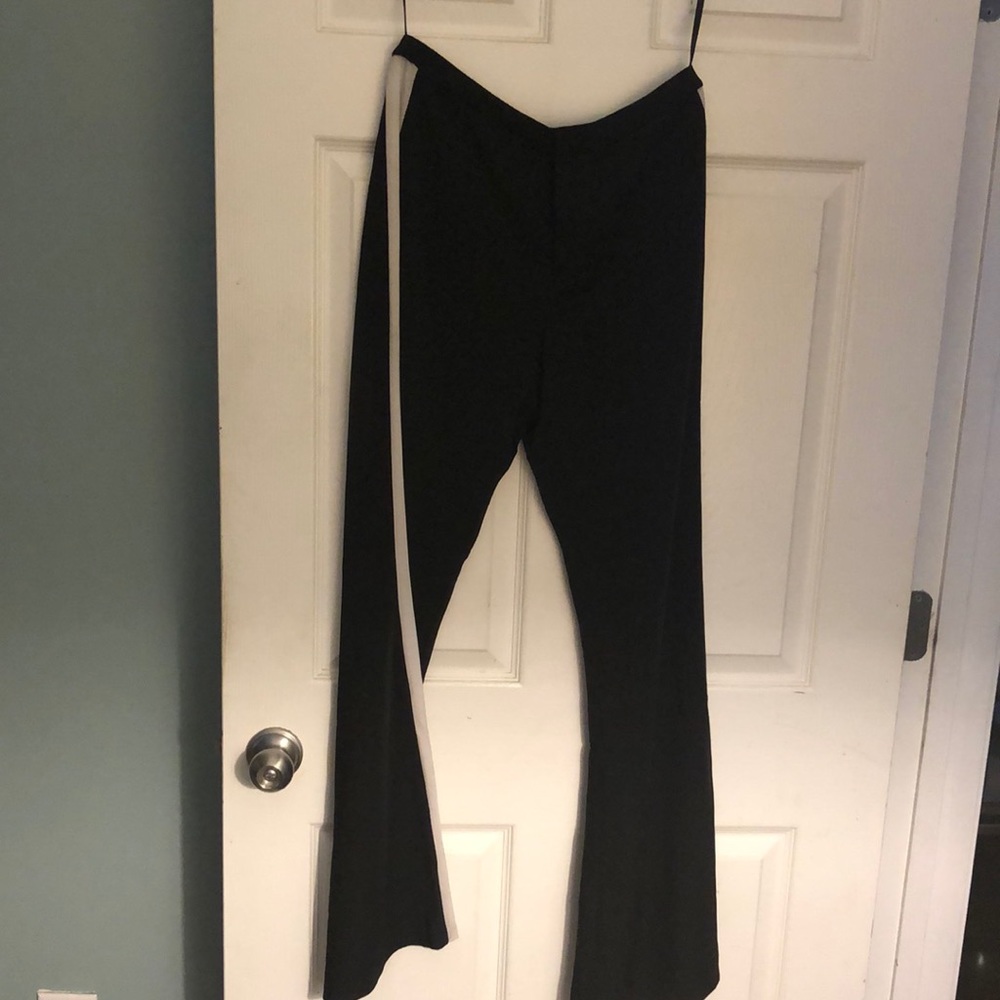 Black pants with white stripes on side legs.